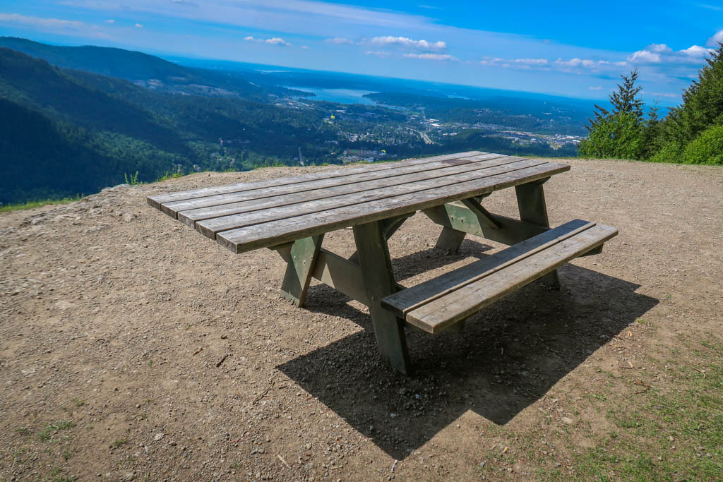 Picnic table at Poo Poo point with view of Puget Sound in the background