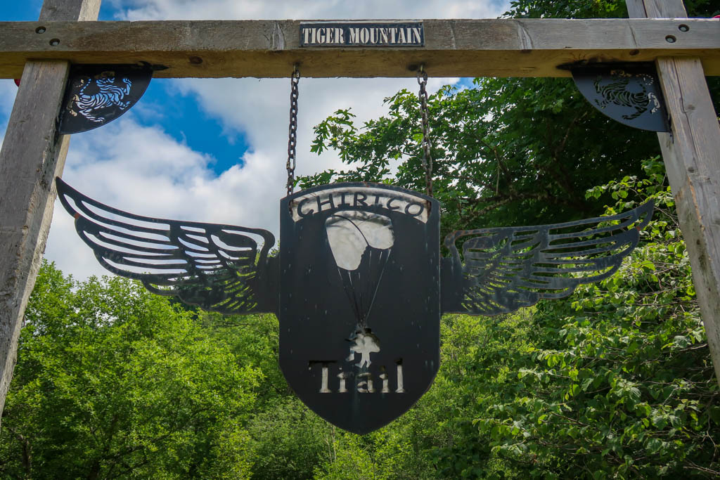 An archway with a winged sign that reads "Chirico Trail" and "Tiger Mountain"