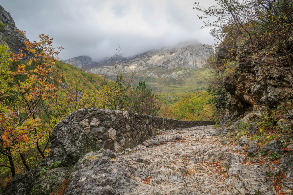 A Paklenica National Park hiking trail leads to the mountains which are shrouded in clouds