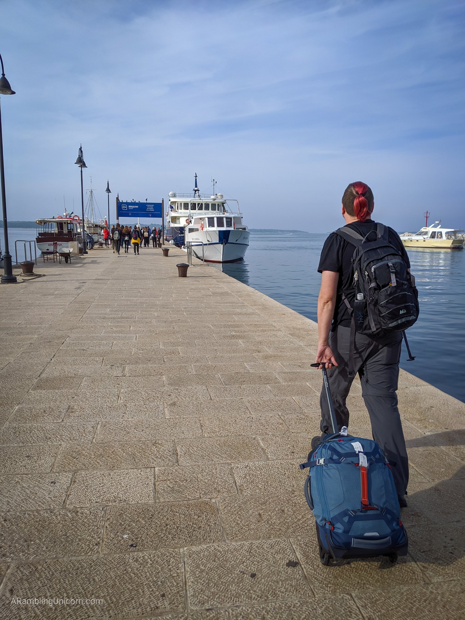 Daniel walks along the dock to the Brijuni Ferry.