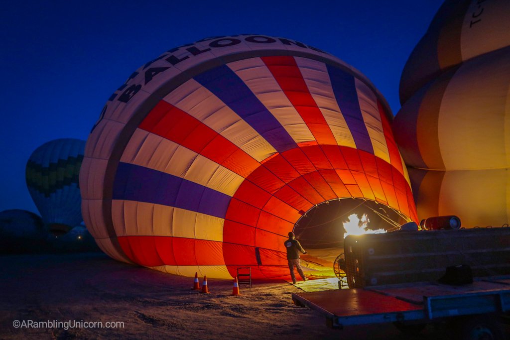 Preparing for the Cappadocia balloon ride: The hot air balloon is first inflated on its side.
