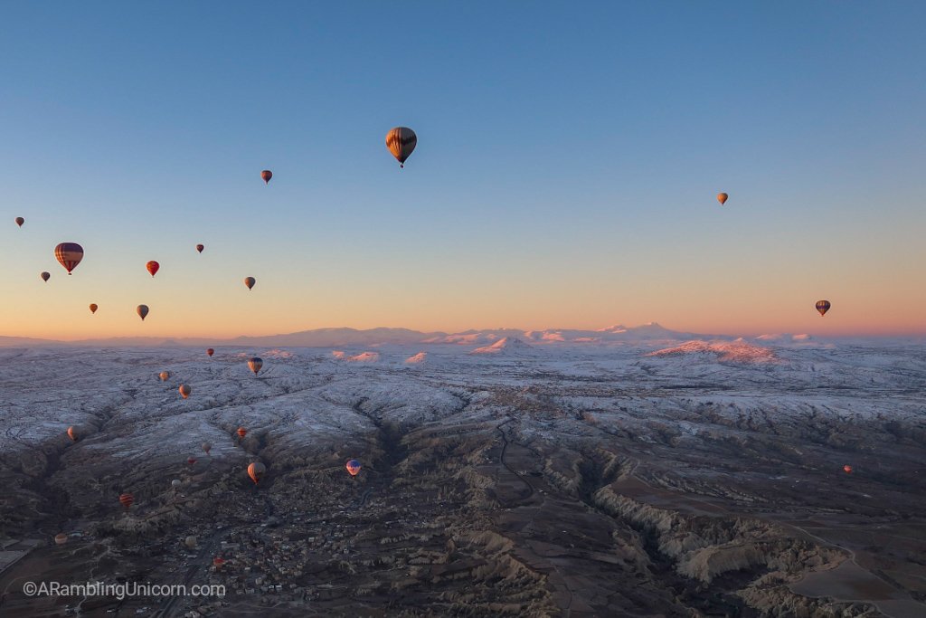After the sun rises, the balloons are bathed in light.