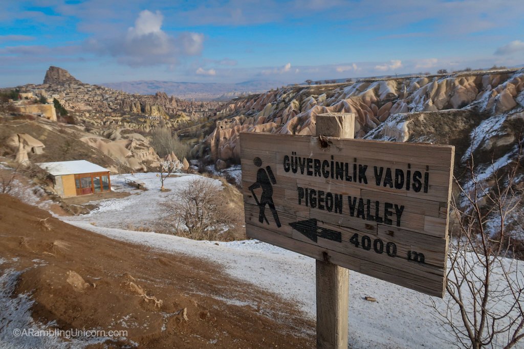 The trailhead for Pigeon Valley Trail with UÃ§hisar Castle in the background.