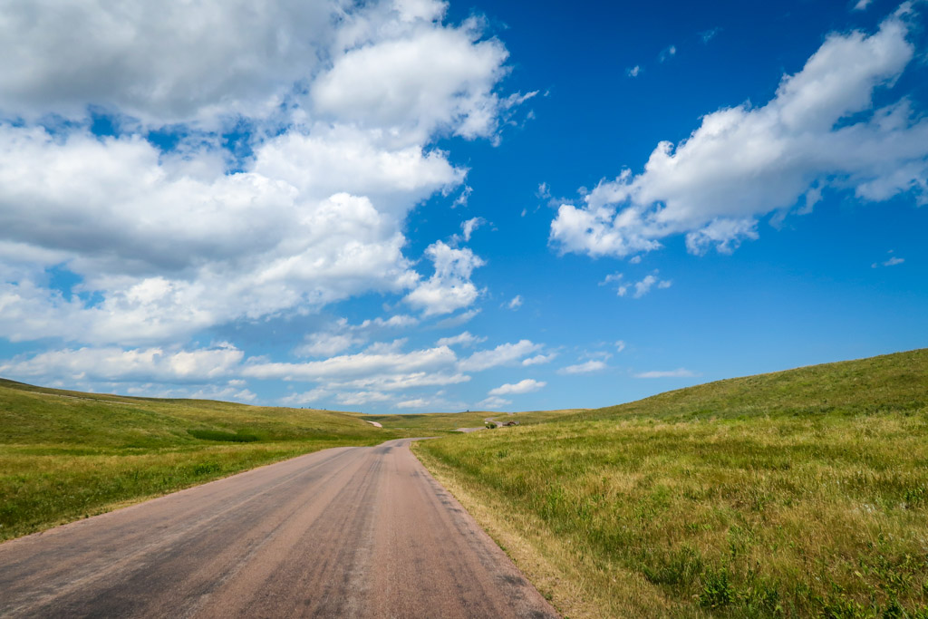 A road stretches through miles of open prairie