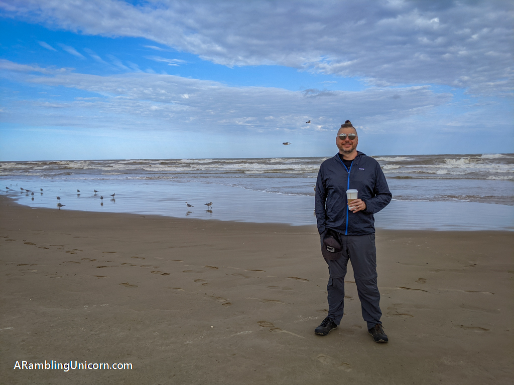 Daniel holds a cup of coffee on the beach at Isla Blanca Park. Its a great way to enjoy a relaxing South Padre Island vacation.