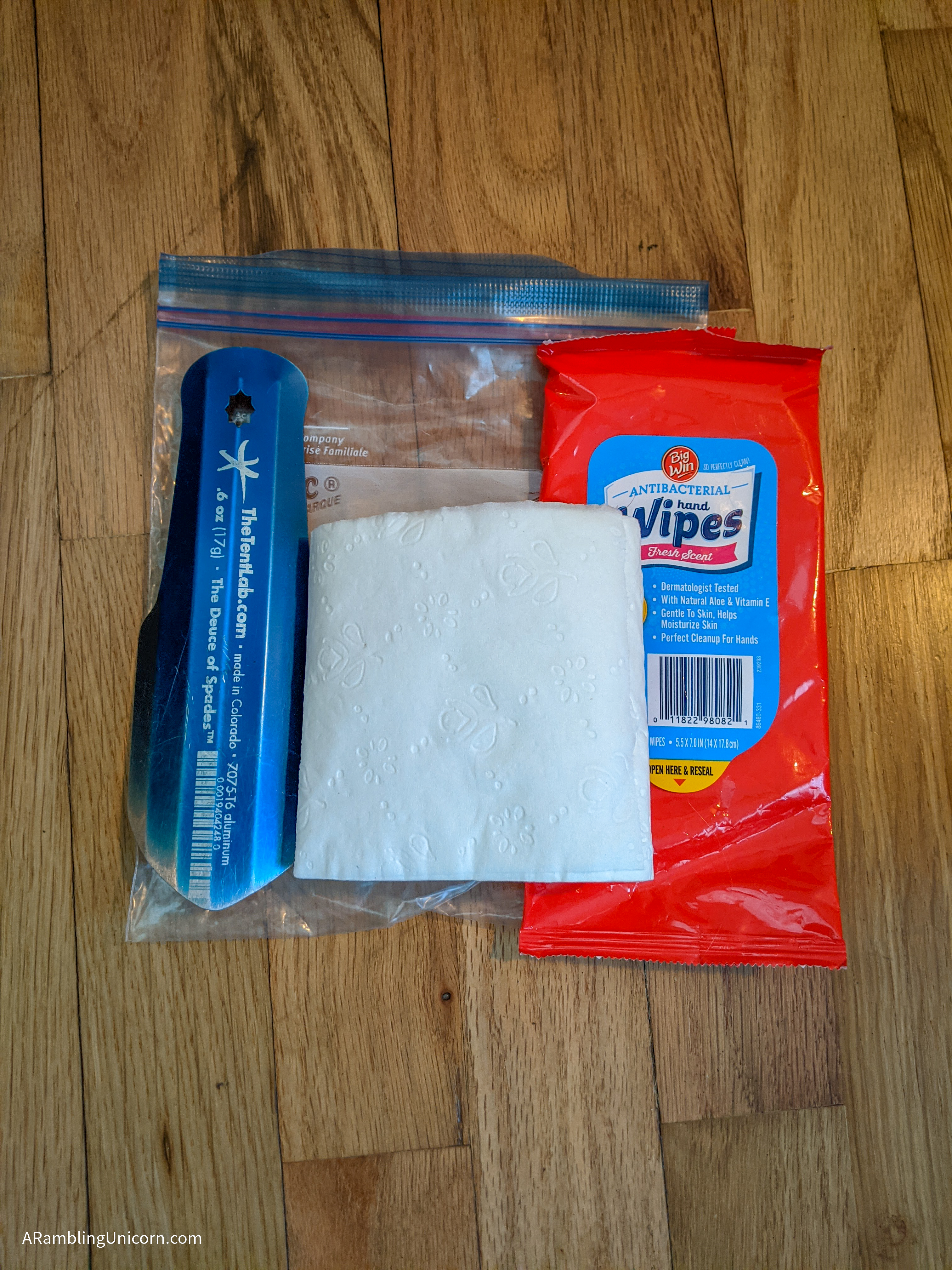 A lightweight trowel, roll of toilet paper and wipes along with a quart-sized Ziploc baggie.