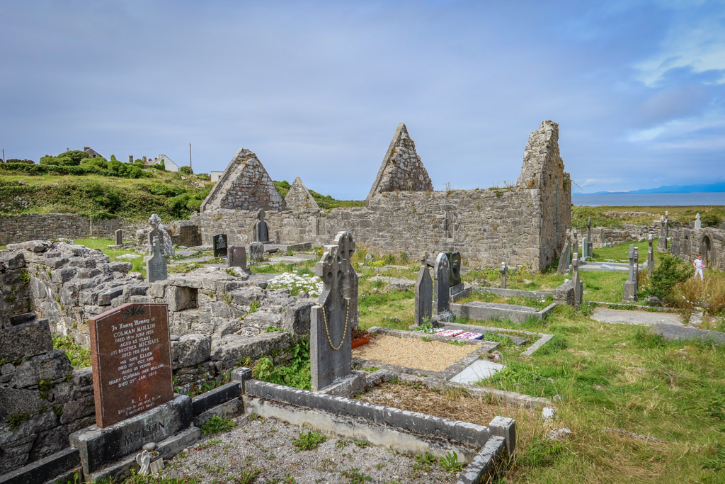 The crumbling remains of two stone churches are located in a graveyard
