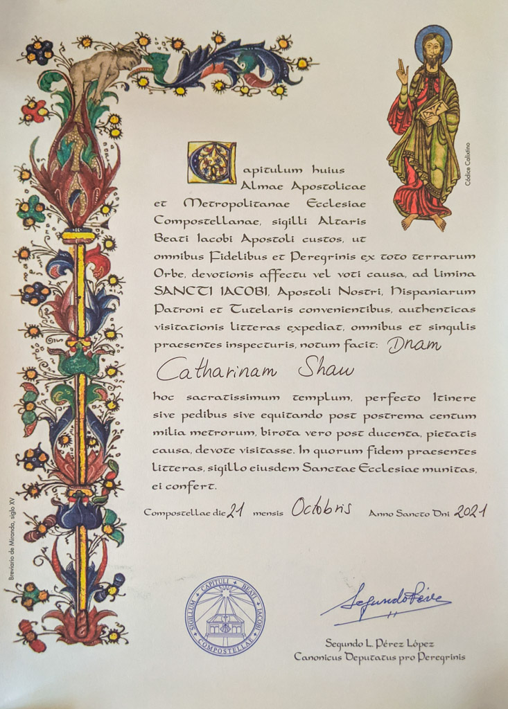 The official Compostela certificate written in Latin with colorful medieval religious images along the edges