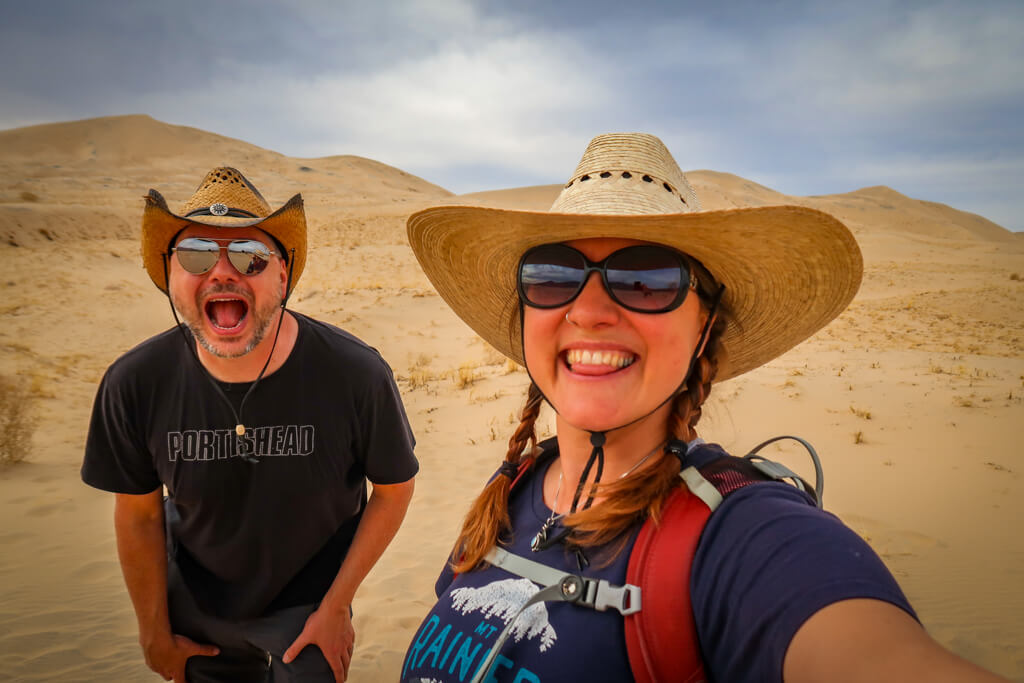 Selfie with Daniel and the author. Mounds of sand dunes are in the background.
