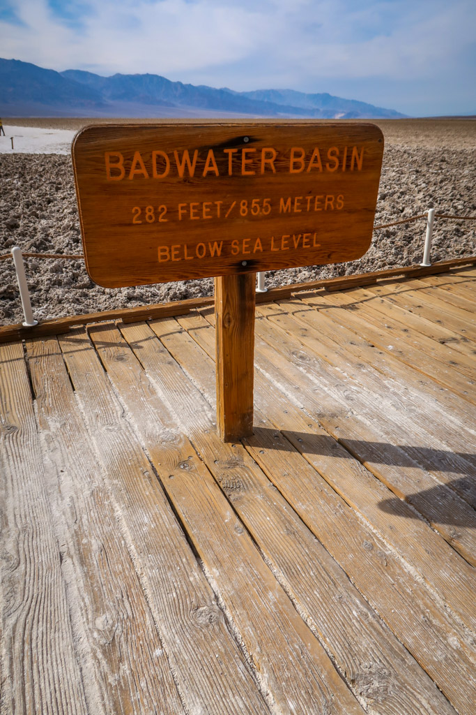 Sign for Badwater Basin in the middle of the salt flats which reads "Badwater Basin: 282 feet/85.5 meters below sea level"