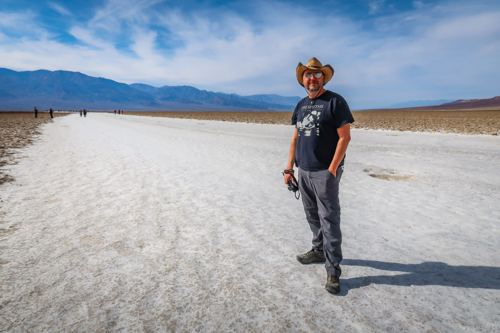 Daniel walks on the Death Valley salt flats on a trail which is comprised of a wide path of crushed white salt and other dried minerals. 