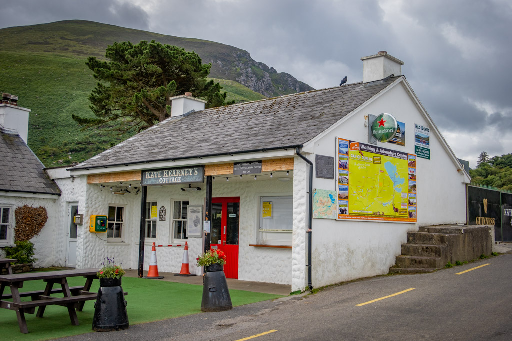 Kate Kearney's Cottage Marks the beginning of the Gap of Dunloe Walk. It is a quaint little building painted white with a red door and picnic tables set outside.