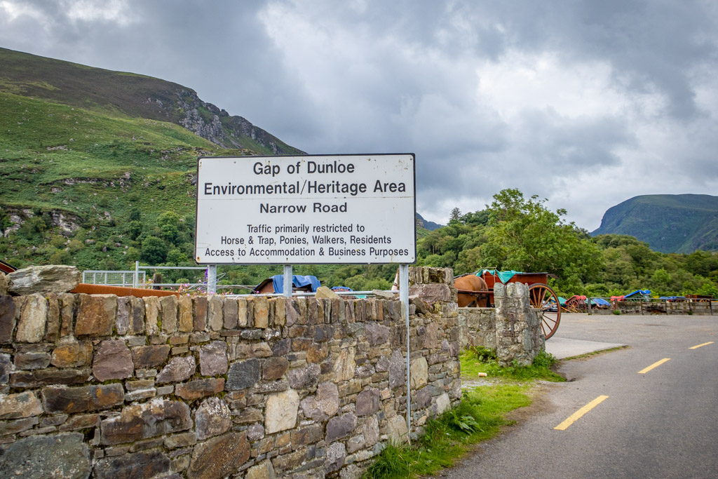 The sign reads "Gap of Dunloe Environmental / Heritage Area. Narrow Road. Traffic primarily restricted to Horse & Trap, Ponies, Walkers, Residents, Access to Accommodation & Business Purposes".