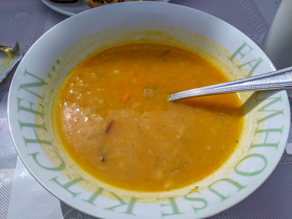 A bowl of creamed vegetable soup with a spoon in it