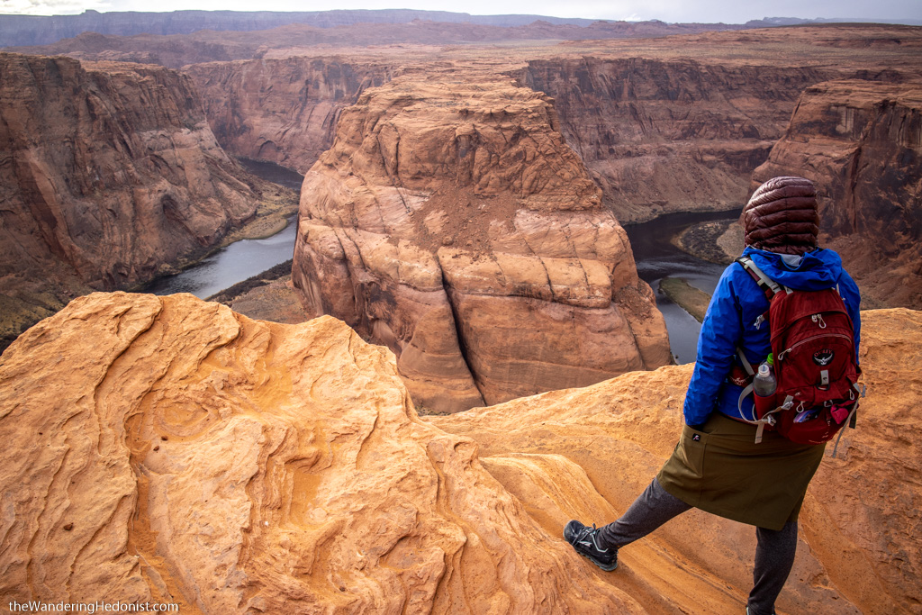 Photo showing the author from the back, standing on the edge of Horseshoe Bend and gazing into the distance.