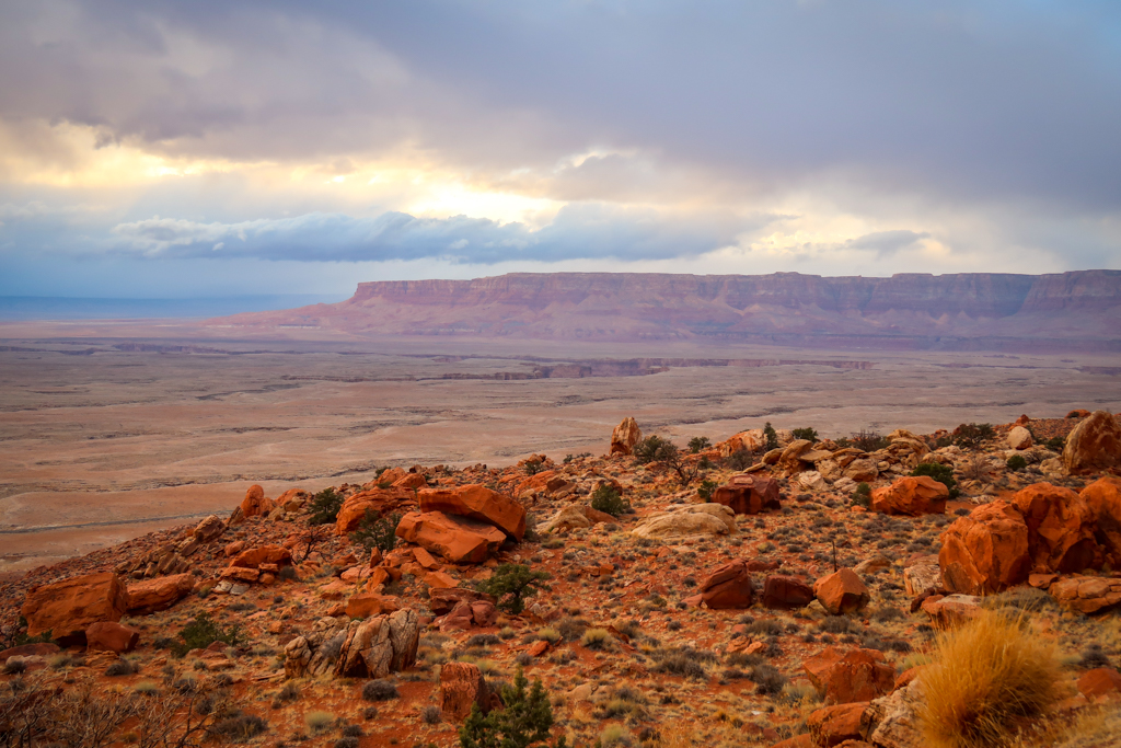 View of the Vermillion Cliffs from Antelope Pass Vista. The red walls rise dramatically from the plateau to form towering Vermillion Cliffs. 