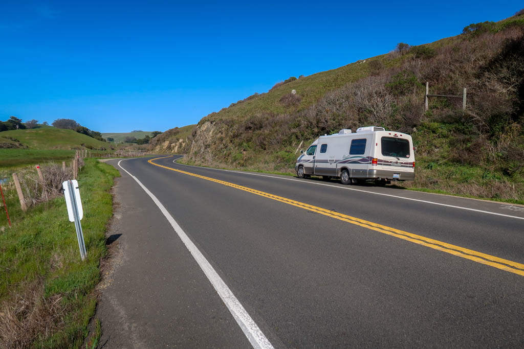 Winnebago Rialta parked along the Pacific Coast Highway through some farmlands in California