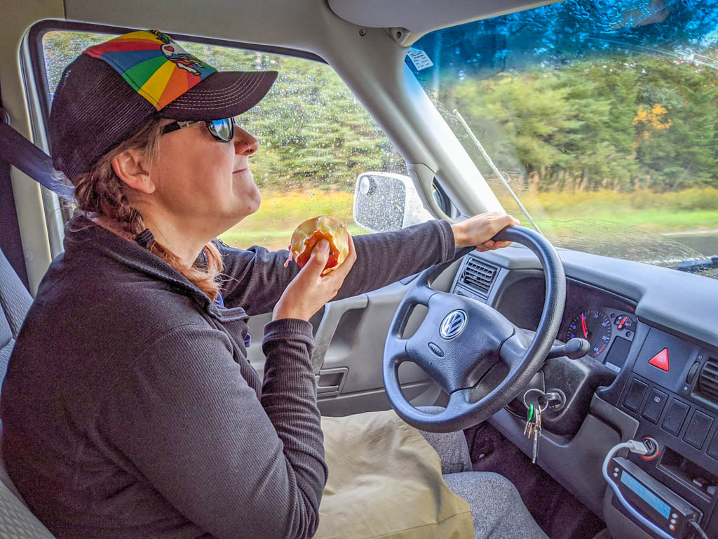 The author eats an apple while driving the motorhome