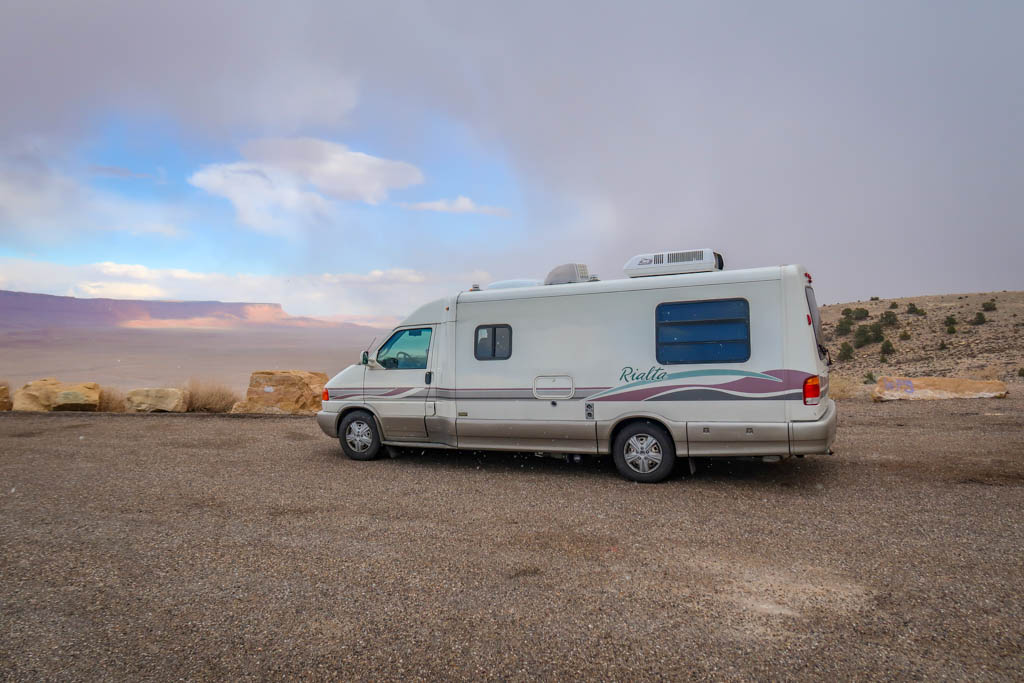 Winnebago Rialta parked at the Pasture Canyon Lookout with views of the Vermillion Cliffs in the distance
